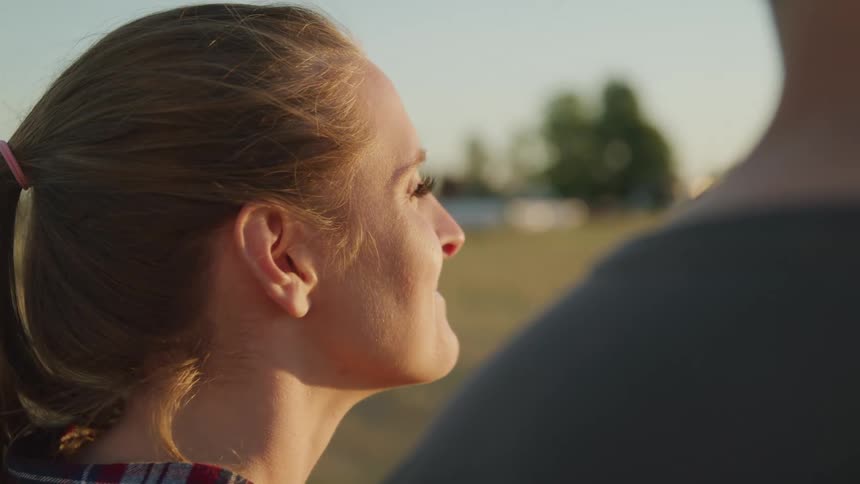 Woman with happy expression next to a man in a field