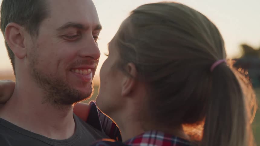 A couple are dancing together at sunrise