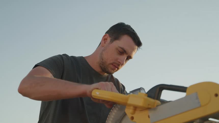 A man uses a power tool