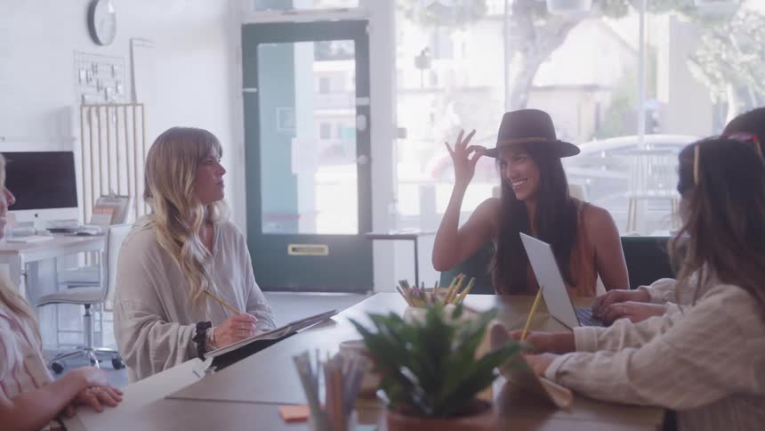 Four women in a work environment sitting and talking