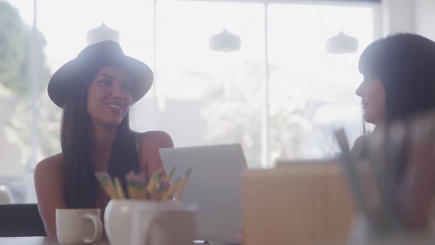 Two women sitting at a table talking