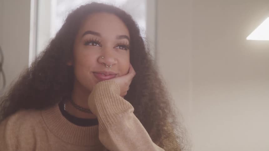 A woman smiling and looking offscreen