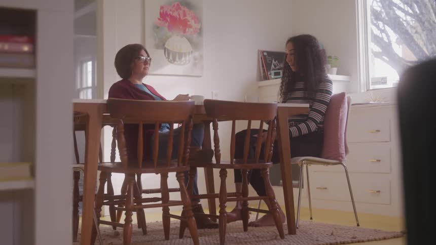 Two women sitting at a table talking