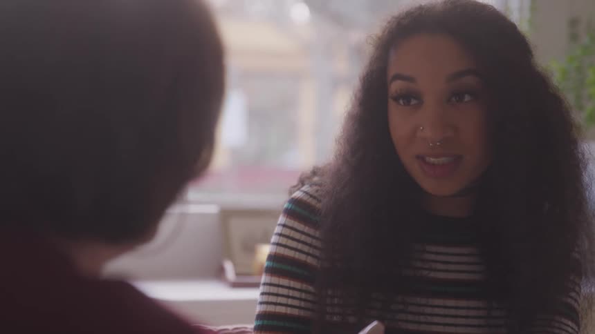 A woman is talking with someone inside