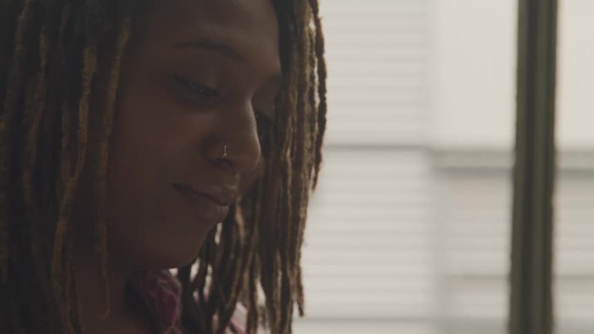 Dreadlocked woman with happy expression