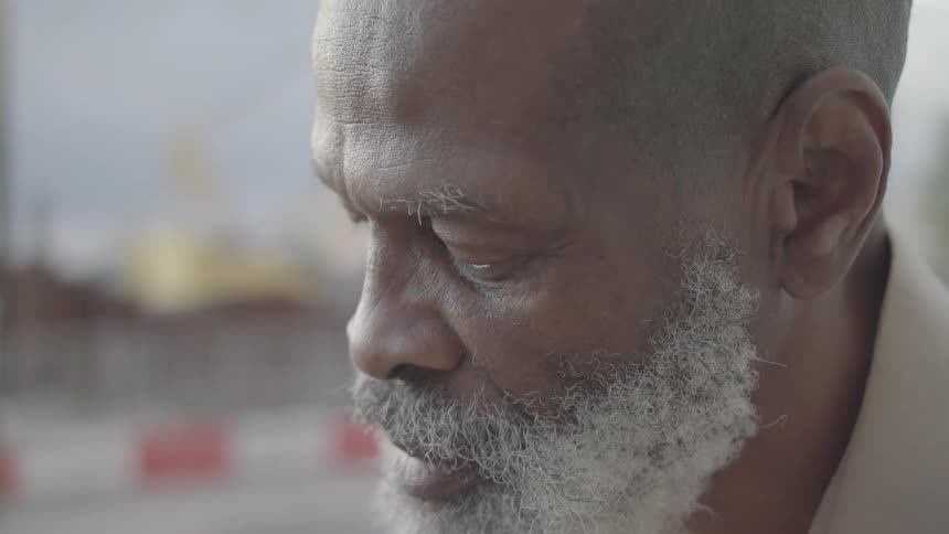 The man talks while looking down