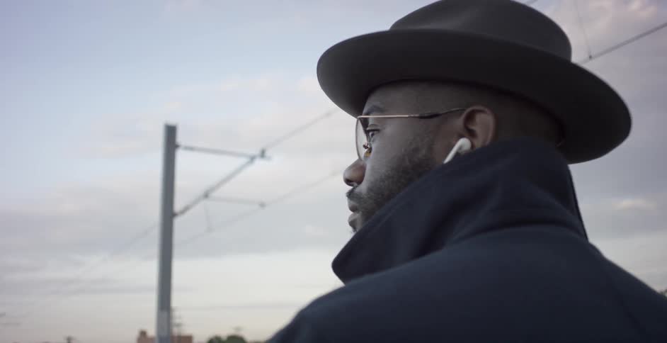 A man wearing a hat and coat