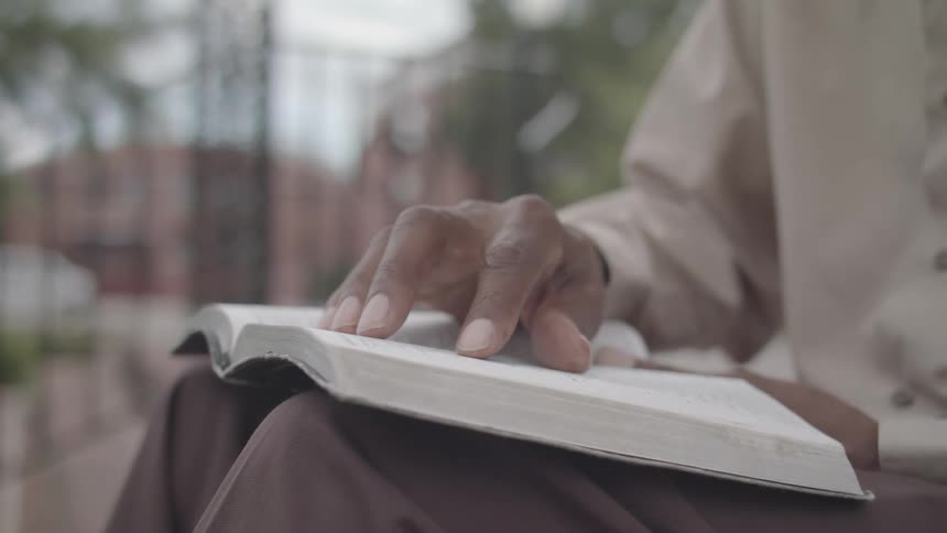 Pair of hands interacting with an open book