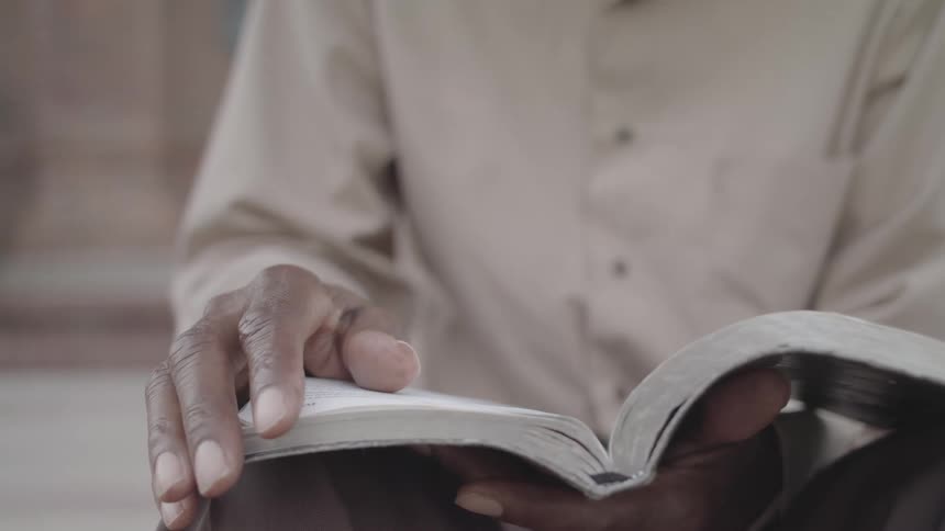 Pair of hands reading a book