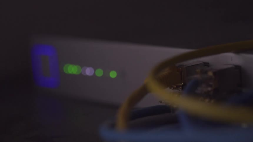 Lights flash on the server rack with many wires