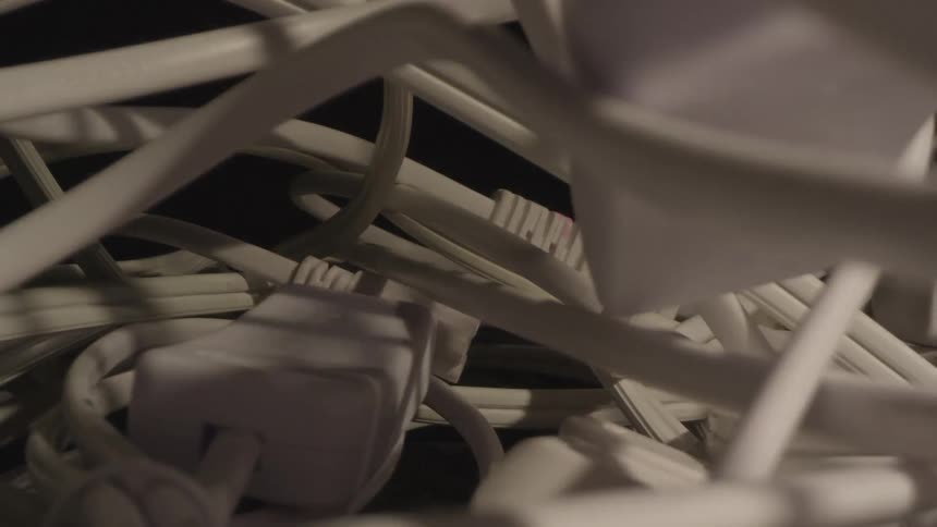 Shadows move over a pile of white cords