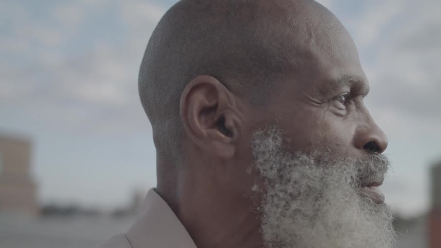 A man stands staring into the distance