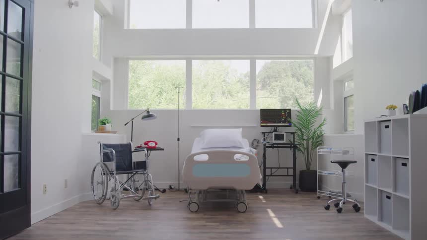 A bright medical room with a hospital bed wheelchair and equipment