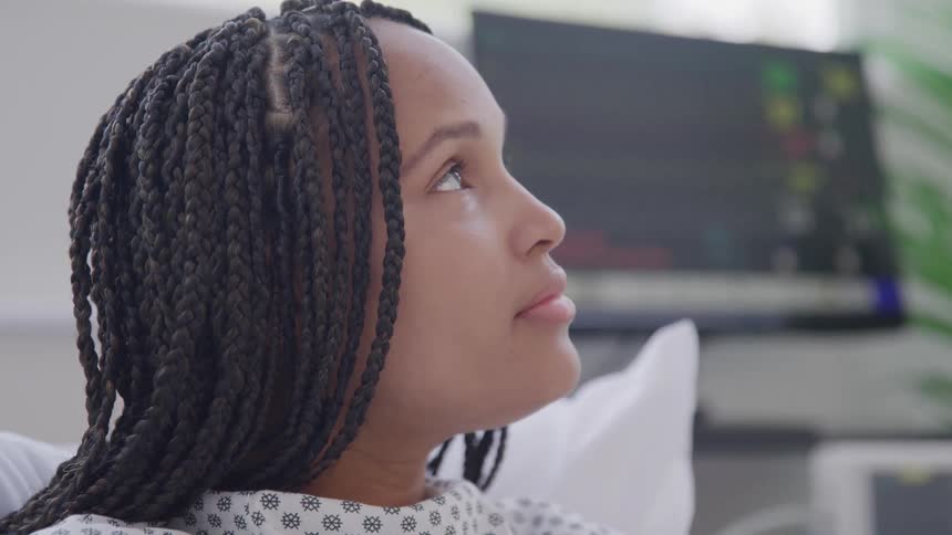 Woman observing while in a hospital room
