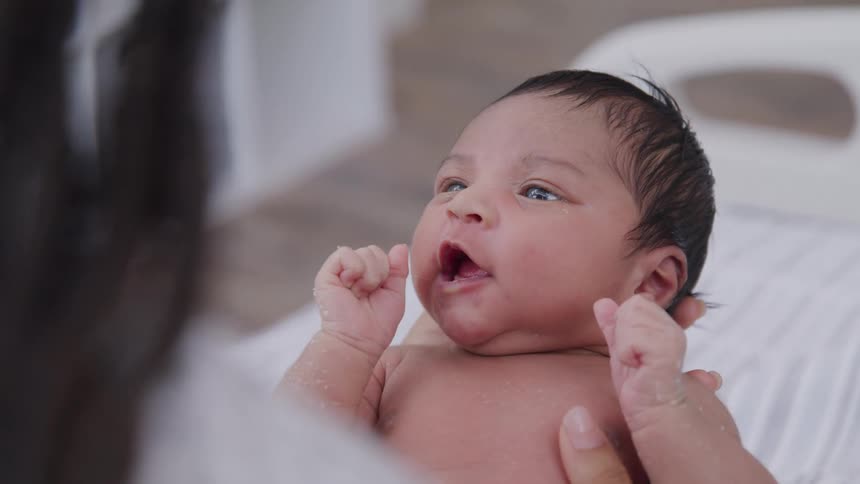 Mother holding her newborn baby in her arms
