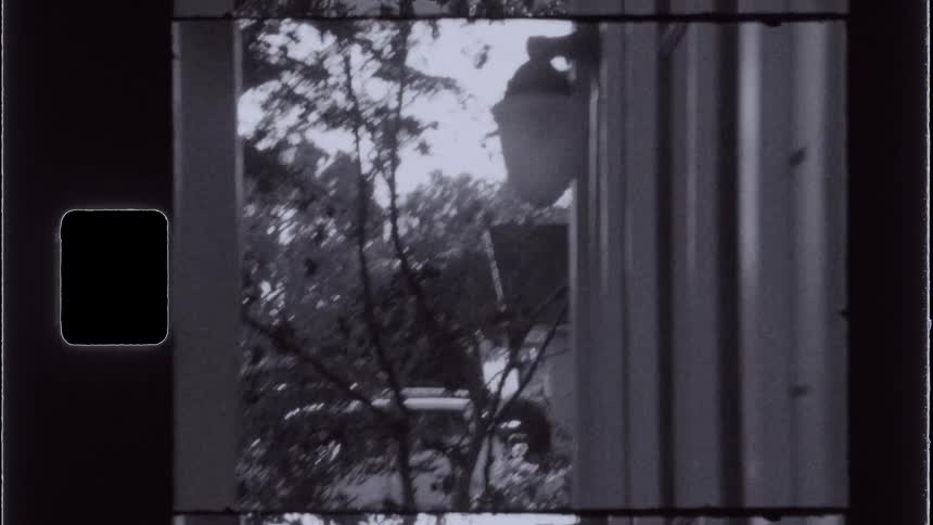 Lamp in an outside hallway and a car in the background