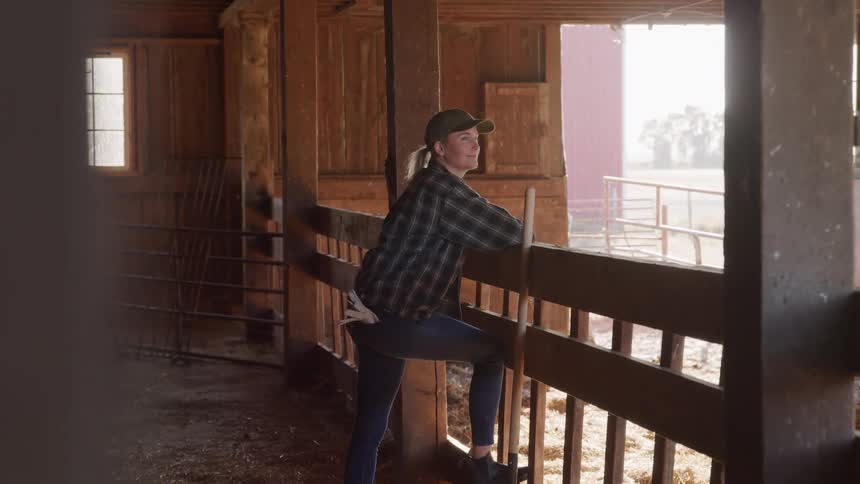 The woman is smiling in her barn
