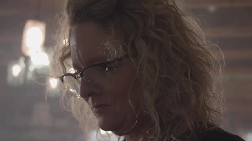 Woman with glasses in an indoor space