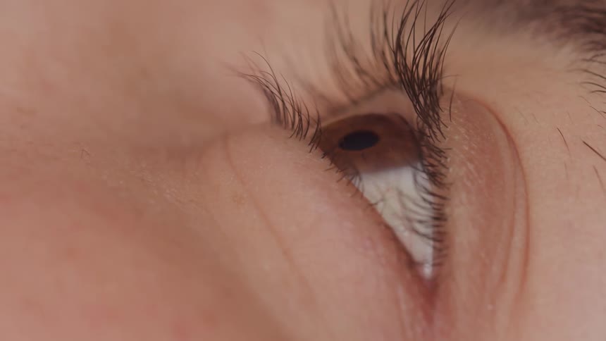 The person blinks their brown eye