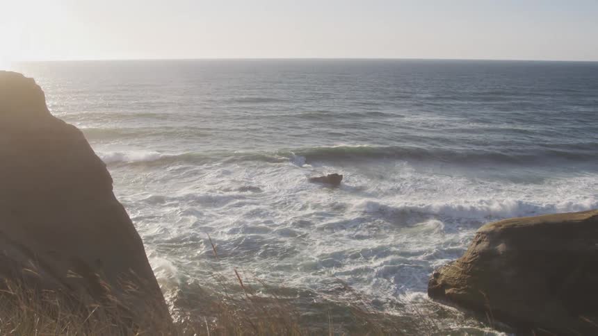 Waves are crashing on the boulders on the shore