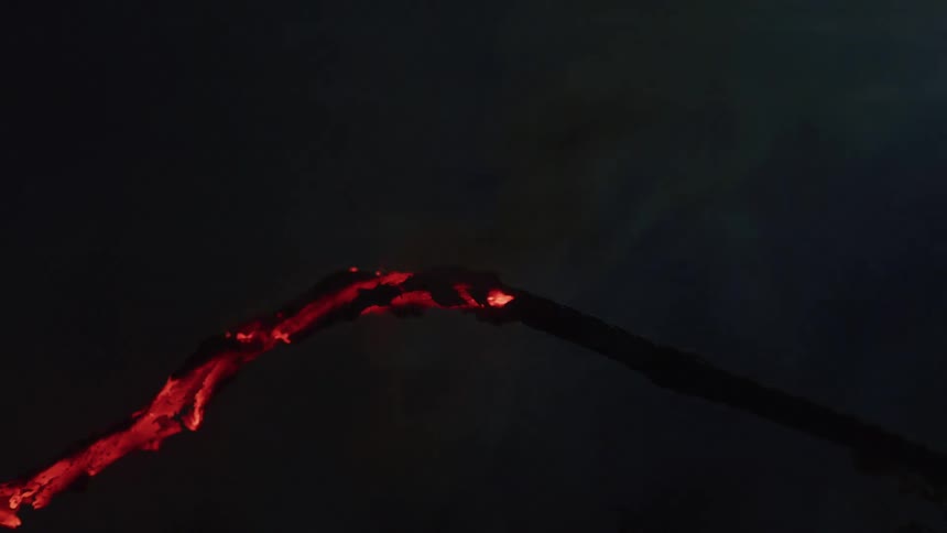 Fire burns wood in the dark at nighttime