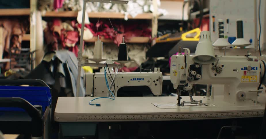 Interior of a shoemaking workshop with machines and leathers on the shelf