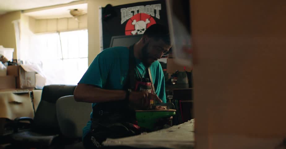 Man in apron working with hand tools