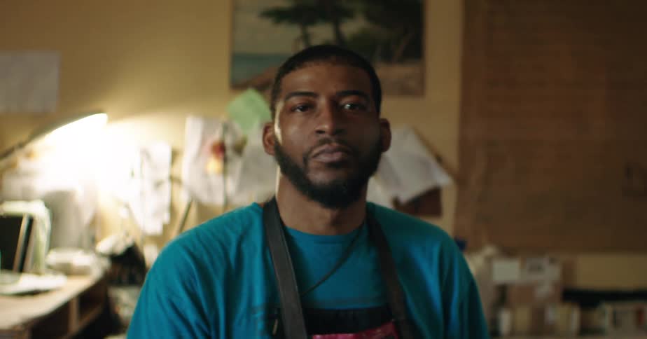 Man sitting with black apron