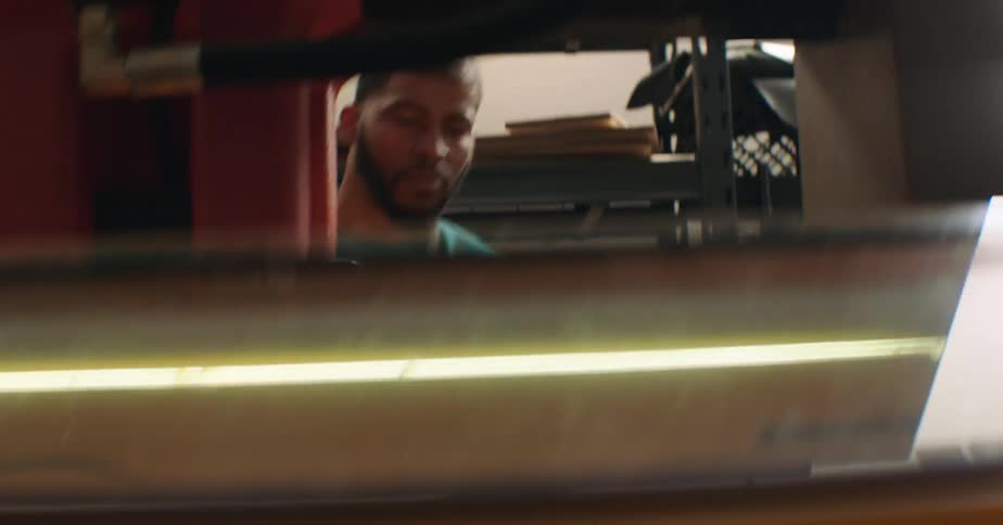 Man thinking fabrics with a manual press machine