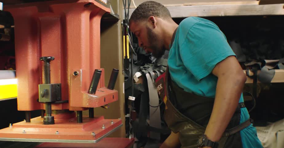 Man in apron working on machinery