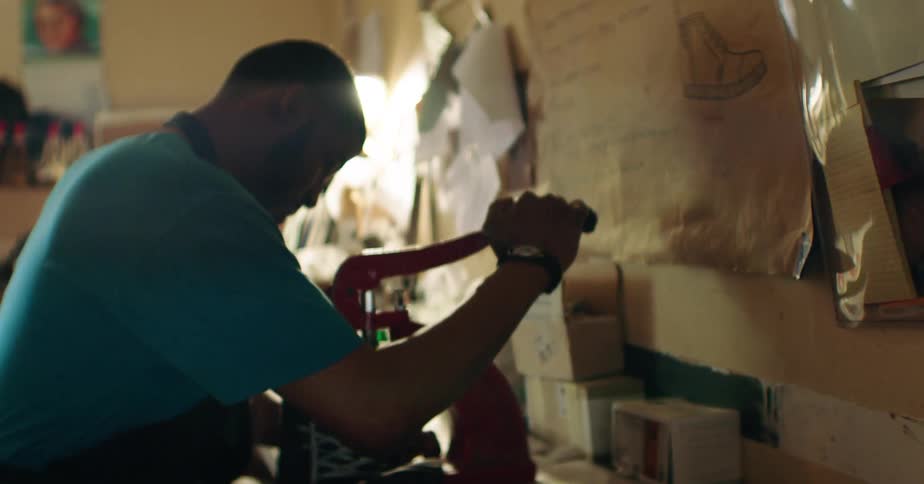 Man working on a hand press machine