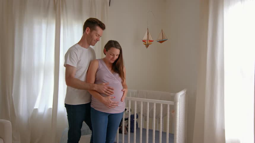 Couple hugging a pregnant woman in a loving moment