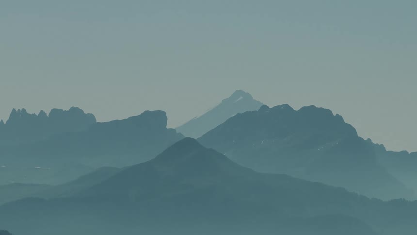 Silhouette of mountains and peaks on a misty day