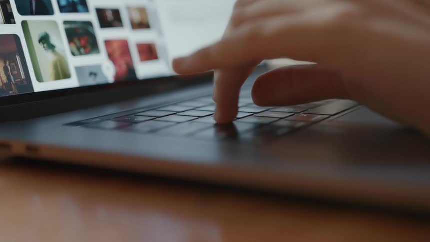 A person types on the laptop keyboard