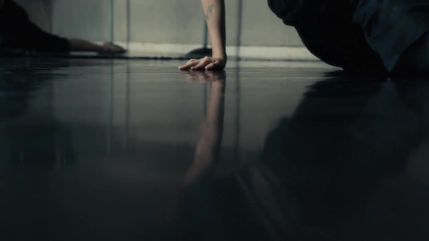The woman is dancing low to the floor