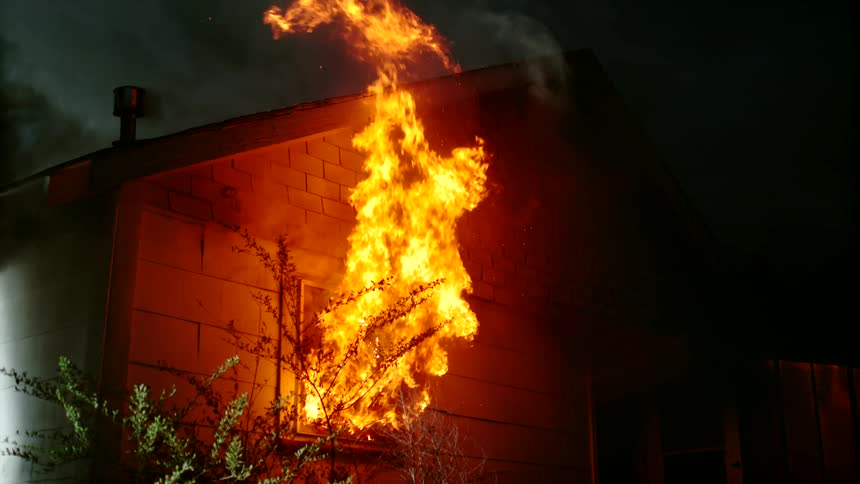 Fire is shooting out of the homes window