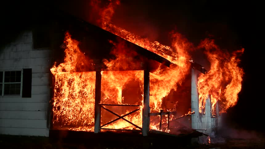Large flames are engulfing the home