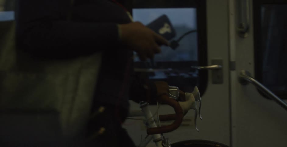 Man climbs onto public transit with bicycle
