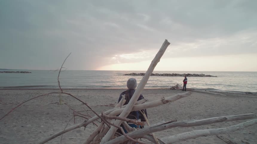 Two people on a beach on a cloudy day
