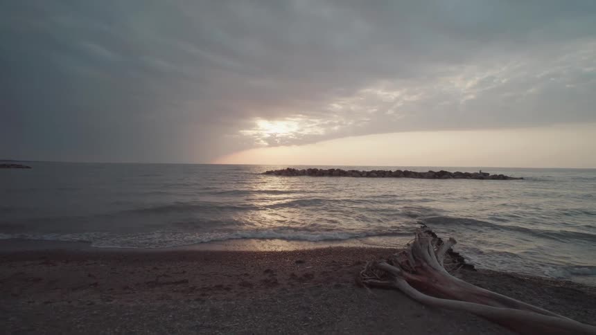 Deserted beach on a cloudy dawn