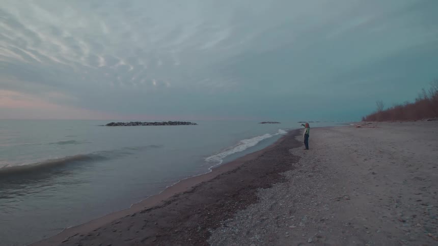 Person alone on a deserted beach one morning