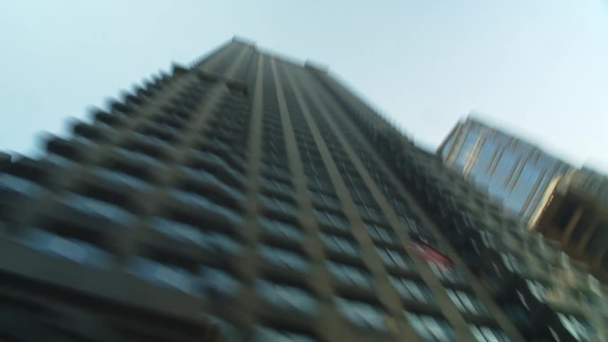 Hyper lapse passing by skyscraper on sunny afternoon