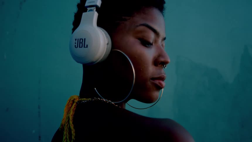 Woman with white jbl headphones