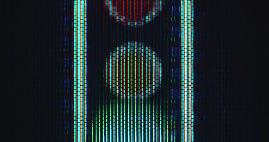 Macro close-up of the digital traffic light animation flashing the blinking yellow light on the pixelated computer display as symbol for a metaphorical yellow card or the last warning before turning red and stopping the traffic or process