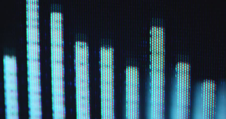 Dynamic hand-held macro shot of glowing equalizer bars pulse on a digital screen reacting to sound waves or dance music being played with a retro audio player device