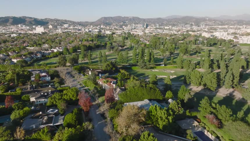 An aerial view over a tree lined neighborhood in Los Angeles