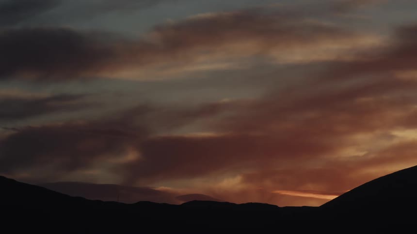 The sky is red as the sun sets