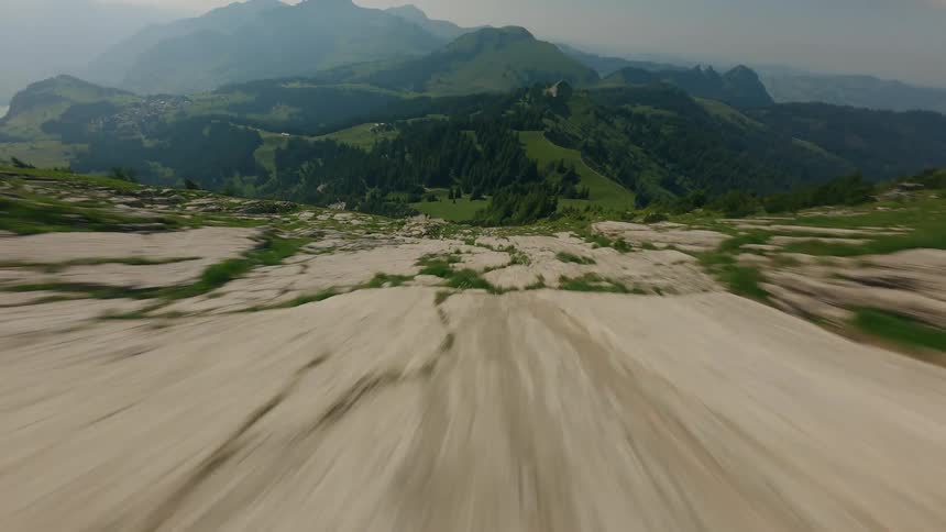 Cinematic FPV Drone Dives Close to Ground on Swiss Mountain