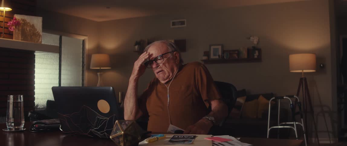 Elderly man having a tense video call at home