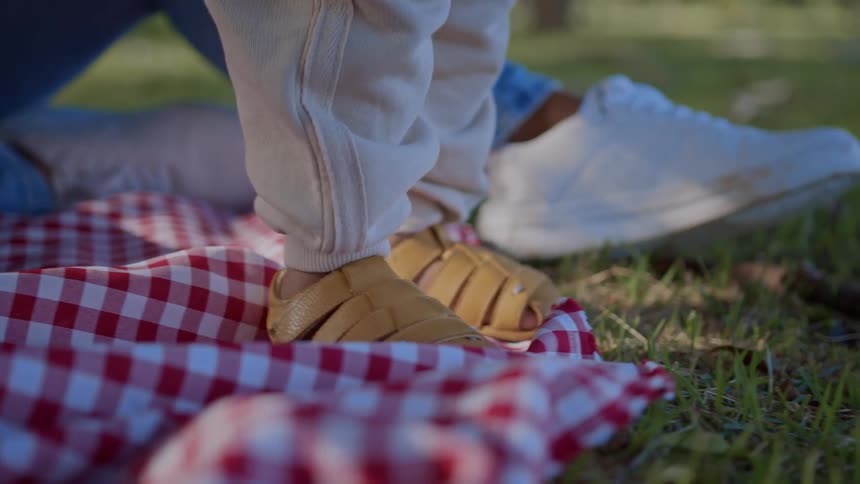 Legs of a small boy walking on the grass